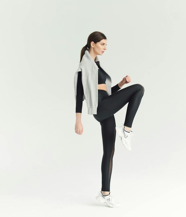 Woman feeling energetic and happy during a cardio workout in a modern studio.